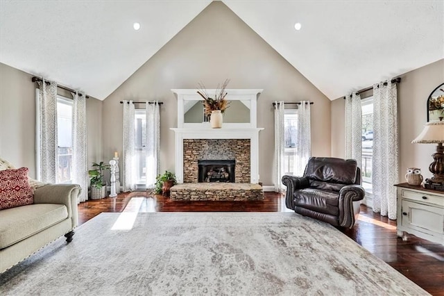 2057 High Shoals Rd, Dallas, GA 30132 - living room with high vaulted ceiling, dark wood-type flooring, a stone fireplace, and plenty of natural light