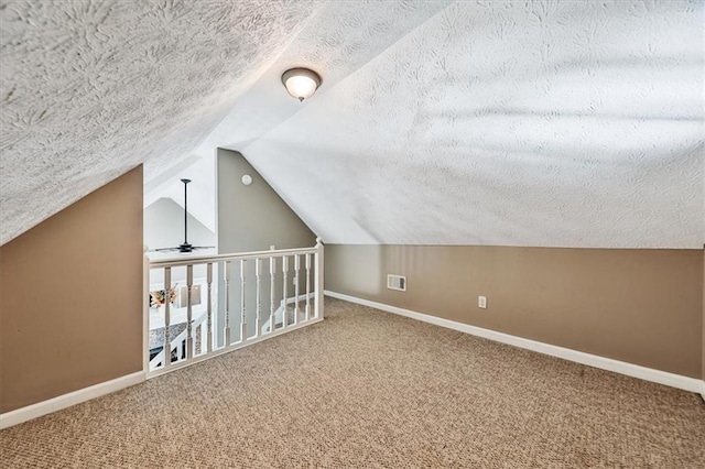2057 High Shoals Rd, Dallas, GA 30132 - bonus room featuring carpet flooring, vaulted ceiling, and a textured ceiling