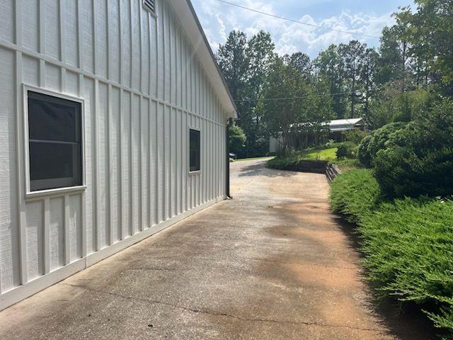 2057 High Shoals Rd, Dallas, GA 30132 - view of home's exterior featuring board and batten siding and a patio