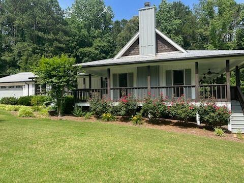 2057 High Shoals Rd, Dallas, GA 30132 - back of house featuring a porch, a yard, a chimney, and ceiling fan