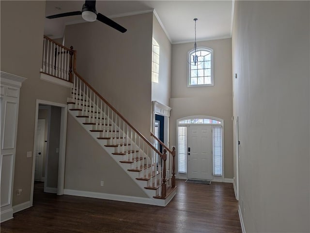 entrance foyer with dark wood-style floors, stairway, and baseboards