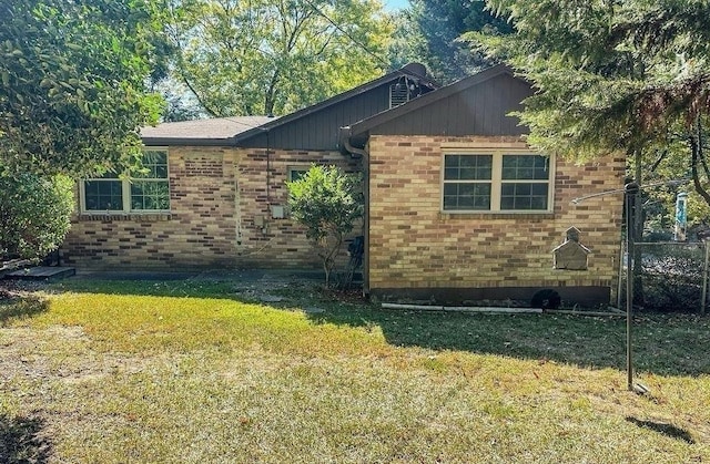 view of home's exterior with a yard