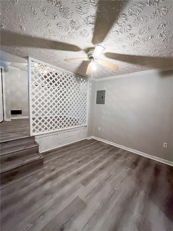 unfurnished room featuring a textured ceiling, ceiling fan, crown molding, hardwood / wood-style flooring, and electric panel