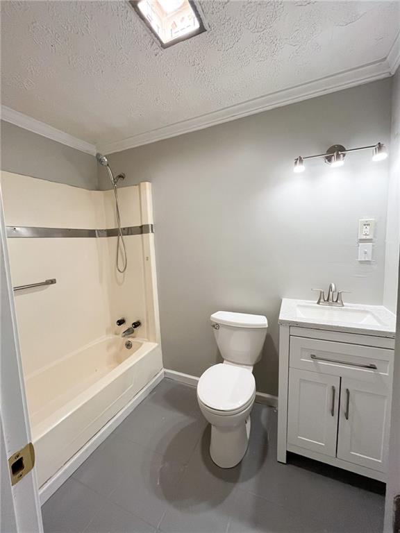 full bathroom with vanity, crown molding, toilet, a textured ceiling, and shower / bath combination