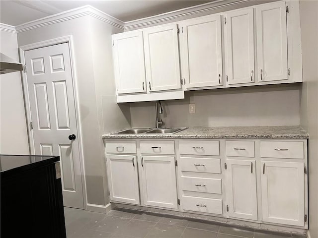 kitchen with white cabinetry, sink, and ornamental molding