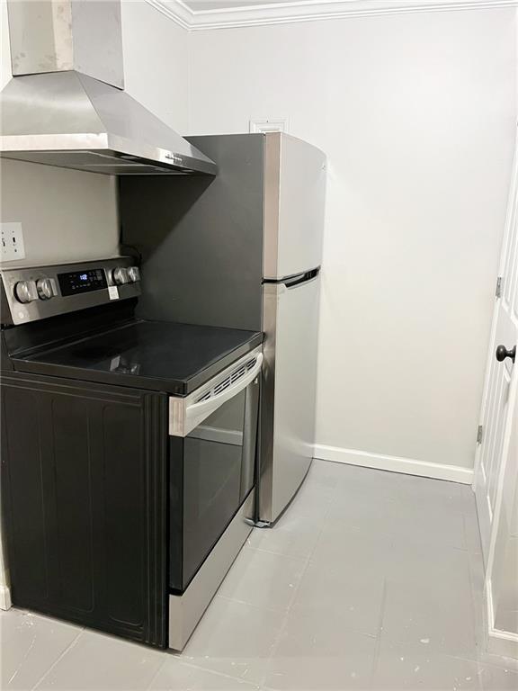 kitchen with wall chimney exhaust hood and stainless steel electric range