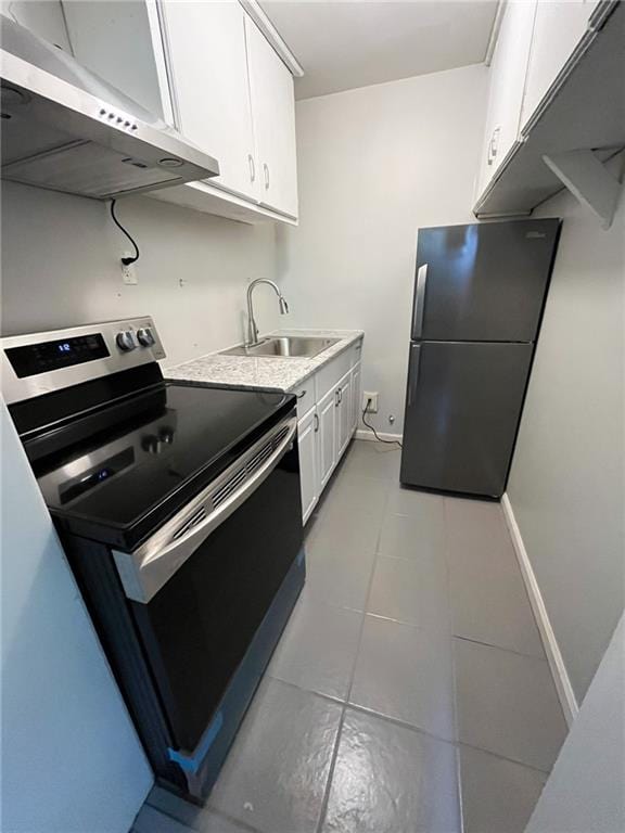 kitchen with ventilation hood, white cabinets, sink, light tile patterned floors, and stainless steel appliances