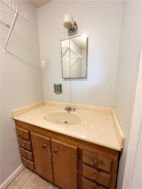 bathroom featuring tile patterned flooring and vanity