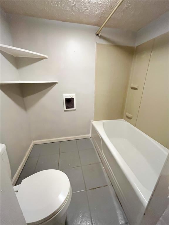 bathroom featuring tile patterned flooring, shower / bath combination, a textured ceiling, and toilet