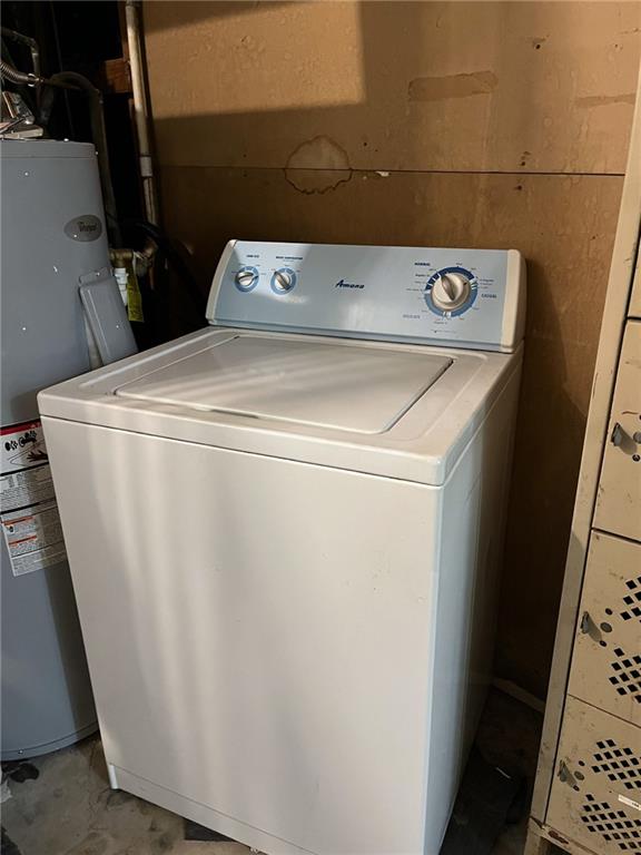 washroom with washer / clothes dryer and water heater