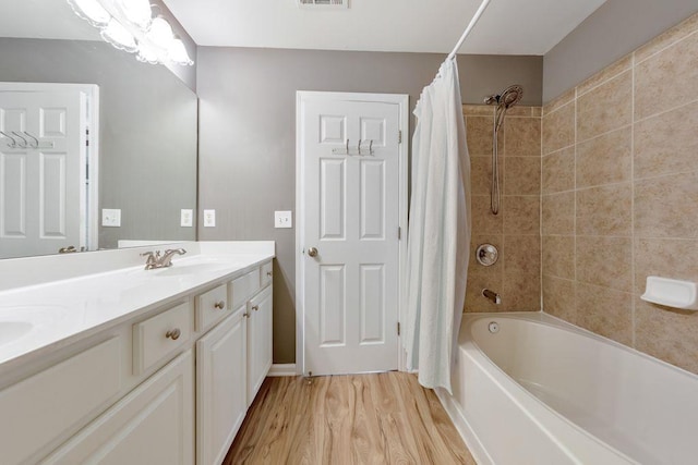 bathroom featuring shower / bathtub combination with curtain, vanity, and wood-type flooring