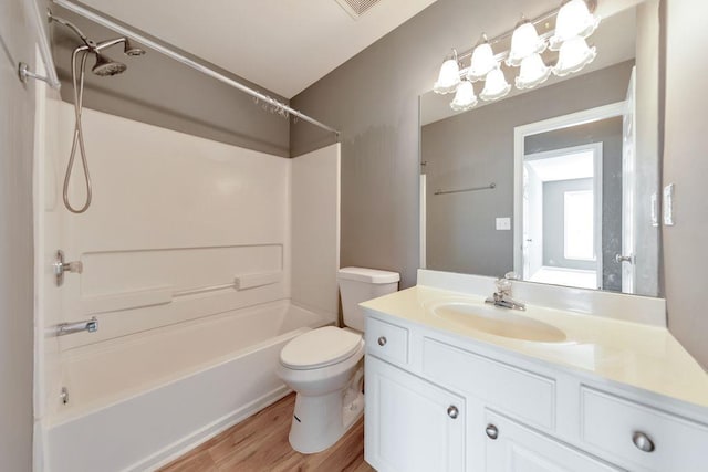 full bathroom featuring vanity, wood-type flooring,  shower combination, and toilet