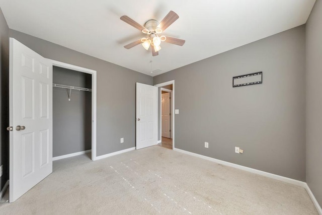 unfurnished bedroom with light carpet, a closet, and ceiling fan