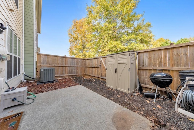 view of patio / terrace with grilling area, central AC unit, and a storage unit