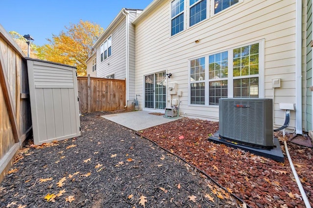 exterior space with a storage shed, central AC unit, and a patio area