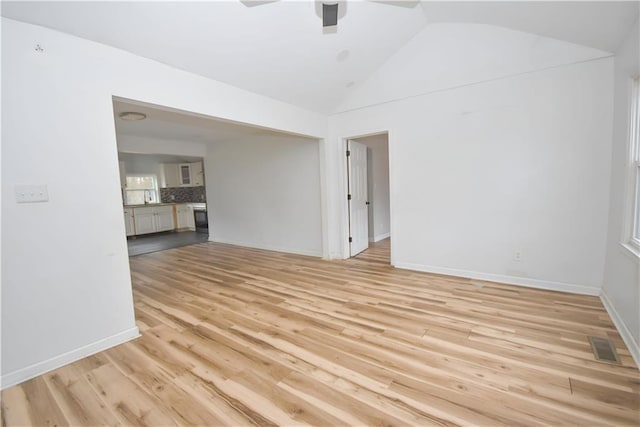 unfurnished living room with ceiling fan, light hardwood / wood-style floors, lofted ceiling, and sink