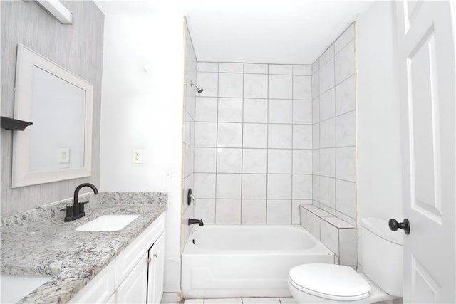 full bathroom featuring toilet, vanity, and tiled shower / bath