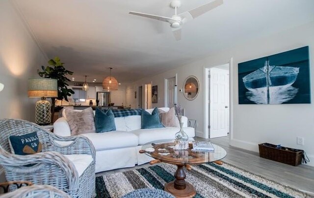 living room with wood-type flooring and ceiling fan