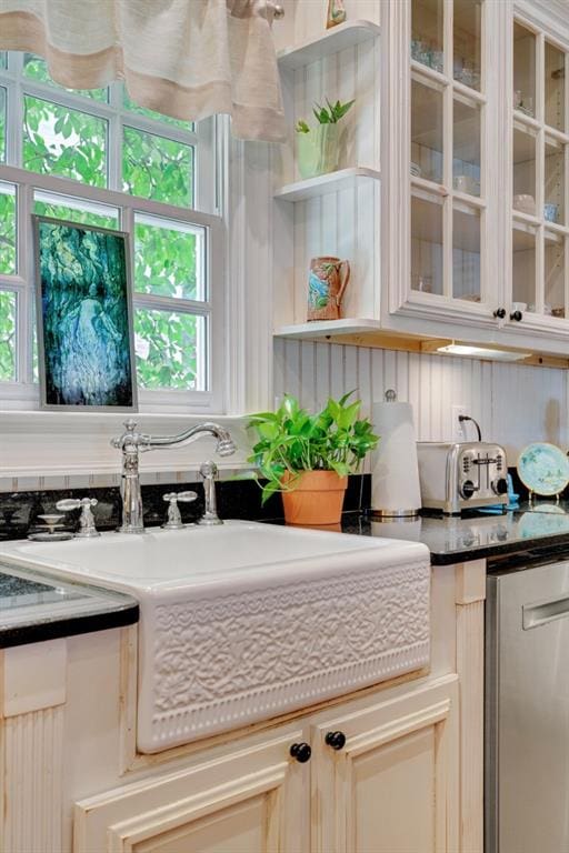 kitchen with sink, dishwasher, and a healthy amount of sunlight