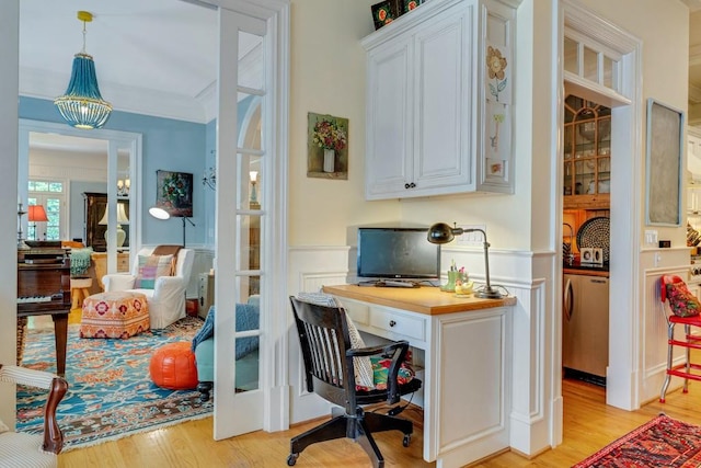 office with washer / clothes dryer, light wood-type flooring, french doors, and a notable chandelier