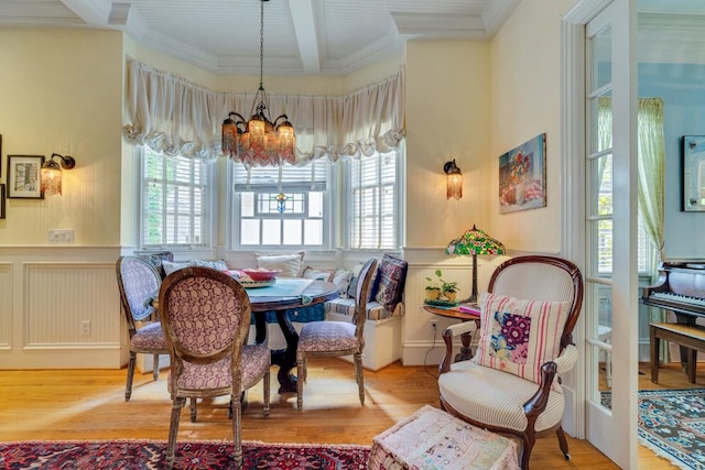 dining room featuring beam ceiling, light wood-type flooring, and a chandelier