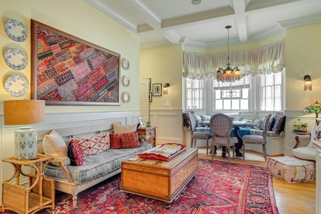 living room with crown molding, an inviting chandelier, beamed ceiling, coffered ceiling, and wood-type flooring