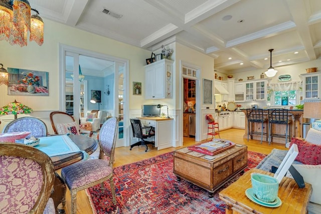 living room with beam ceiling, coffered ceiling, light wood-type flooring, and a chandelier