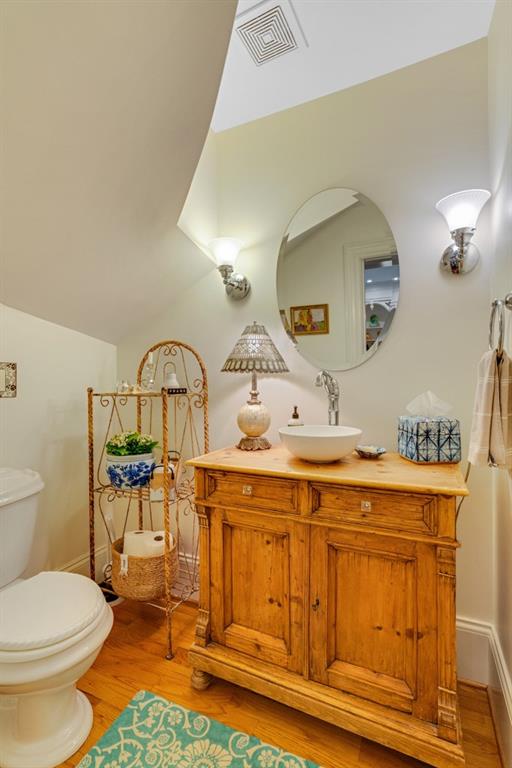 bathroom featuring hardwood / wood-style floors, toilet, and vanity