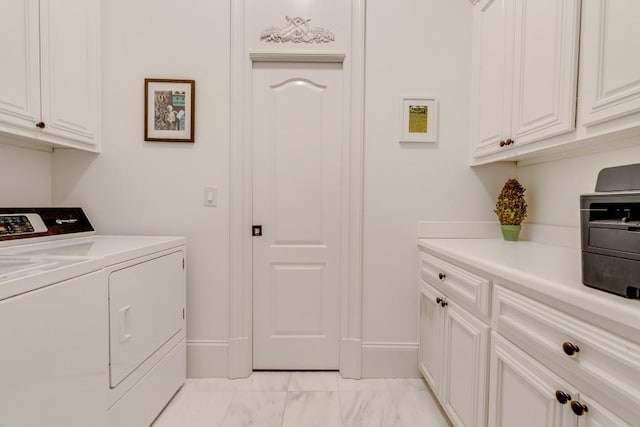 clothes washing area featuring washer and clothes dryer, cabinets, and light tile patterned floors