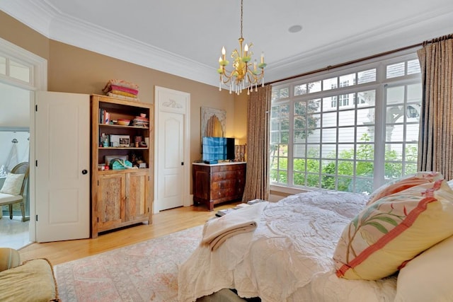 bedroom featuring multiple windows, ornamental molding, light hardwood / wood-style flooring, and a notable chandelier