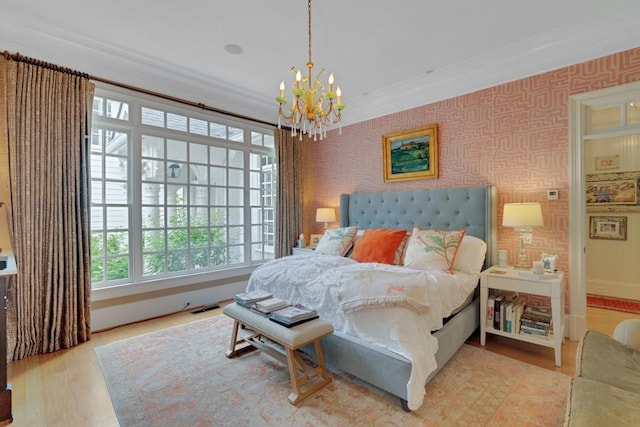 bedroom with a chandelier, crown molding, and light hardwood / wood-style floors