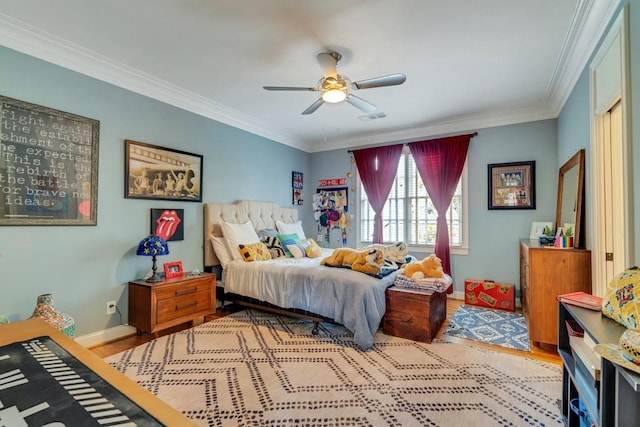 bedroom featuring crown molding, light wood-type flooring, and ceiling fan