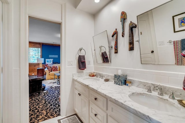 bathroom featuring tile patterned flooring and dual bowl vanity