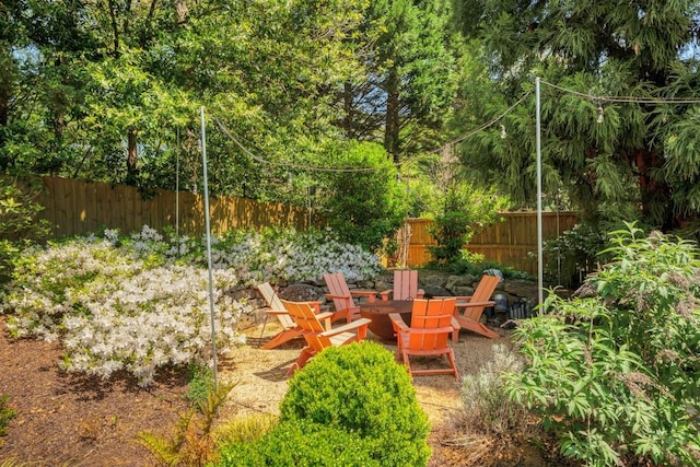 view of yard featuring an outdoor fire pit