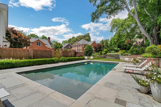 view of swimming pool with a patio area