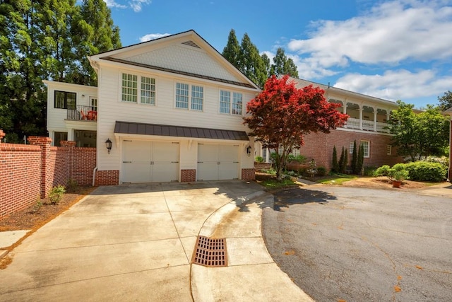 view of front of home with a garage and a balcony