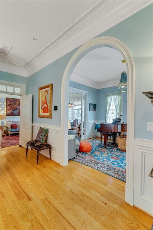 corridor featuring light hardwood / wood-style flooring and ornamental molding