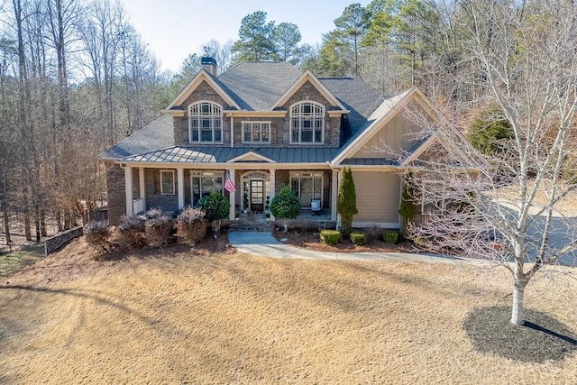 craftsman inspired home featuring a front yard and a porch