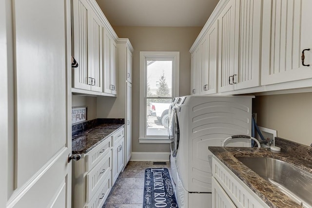 laundry room featuring sink, cabinets, and washing machine and clothes dryer