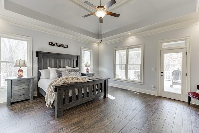 bedroom with ornamental molding, access to outside, dark hardwood / wood-style flooring, and a raised ceiling