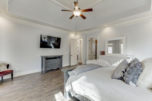 bedroom featuring ceiling fan, crown molding, wood-type flooring, and a raised ceiling