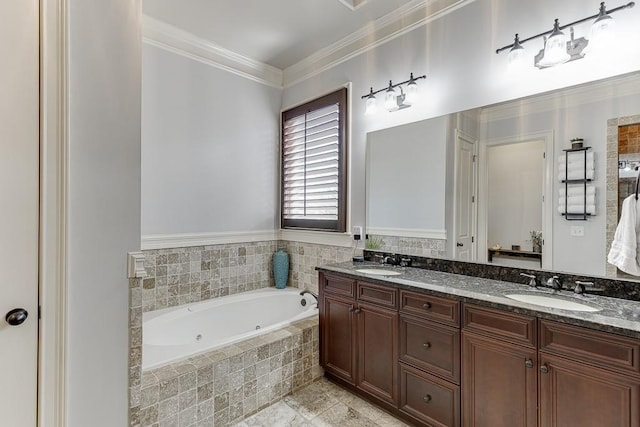 bathroom featuring ornamental molding, vanity, and tiled tub