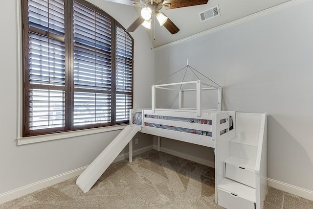 bedroom with ornamental molding and light carpet