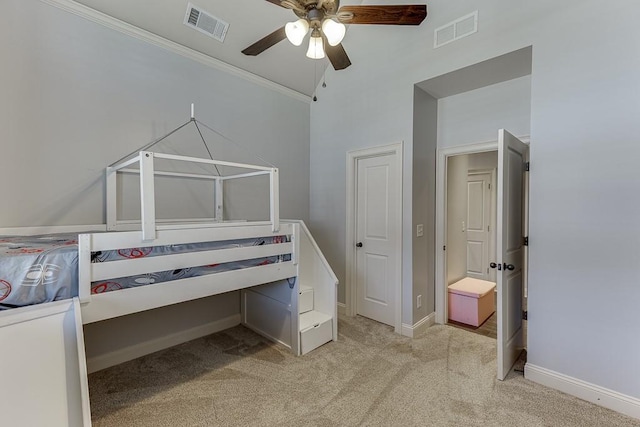 bedroom featuring ceiling fan, vaulted ceiling, crown molding, and light colored carpet