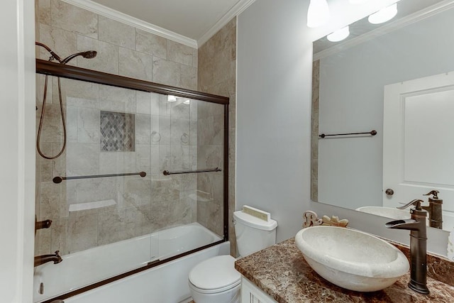 full bathroom featuring ornamental molding, vanity, enclosed tub / shower combo, and toilet