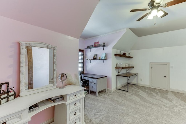 carpeted office space with vaulted ceiling and ceiling fan