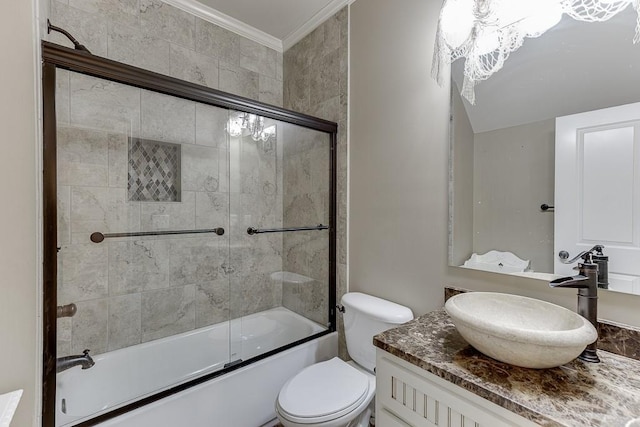 full bathroom with toilet, crown molding, combined bath / shower with glass door, and vanity