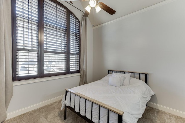 carpeted bedroom with ceiling fan and ornamental molding