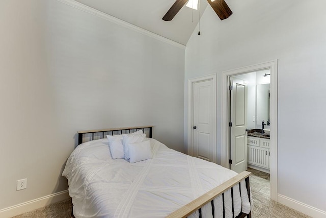 carpeted bedroom featuring ensuite bathroom, high vaulted ceiling, and ceiling fan