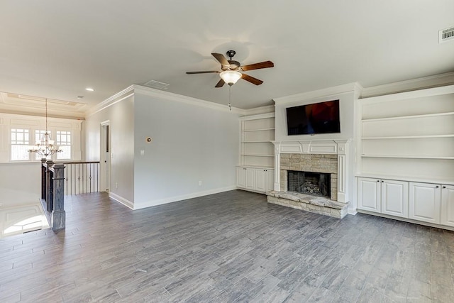 unfurnished living room with ceiling fan with notable chandelier, hardwood / wood-style flooring, ornamental molding, and a fireplace